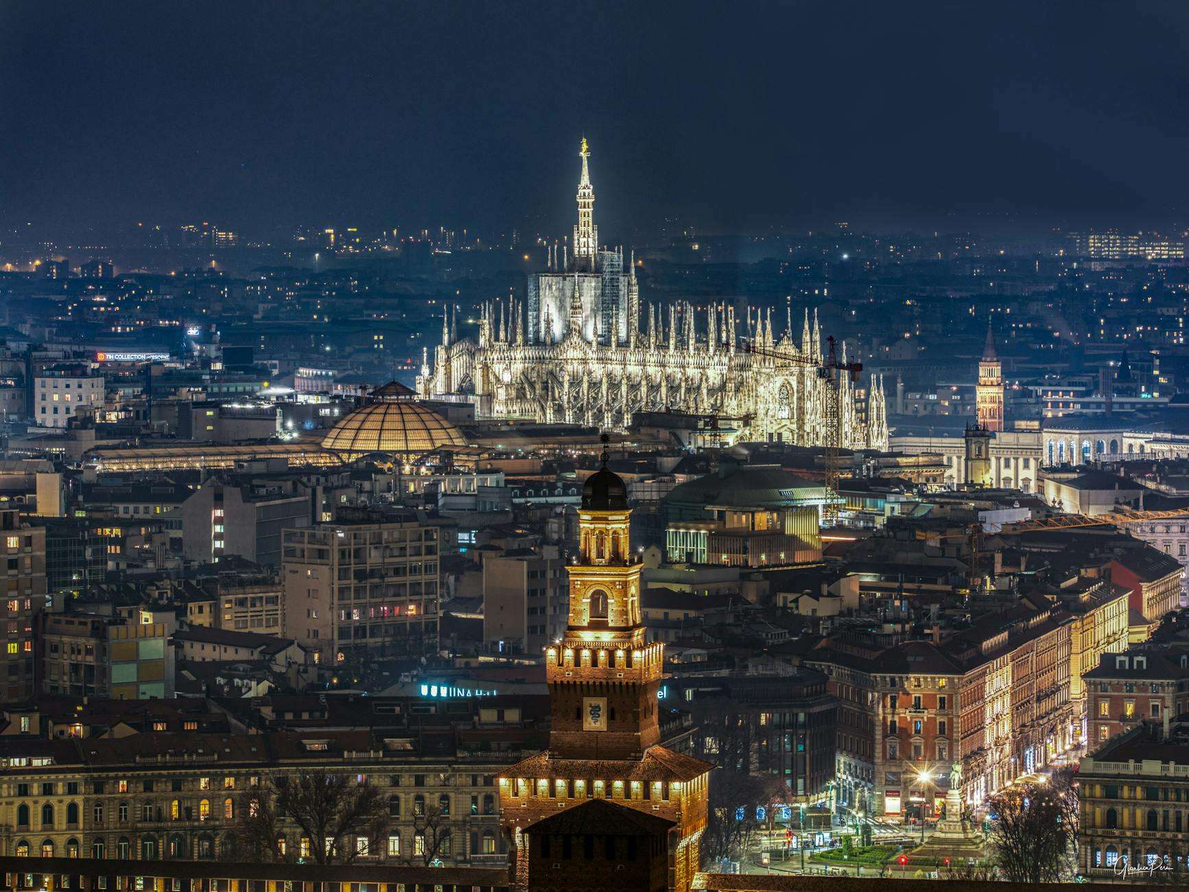 milan cathedral over city at night
