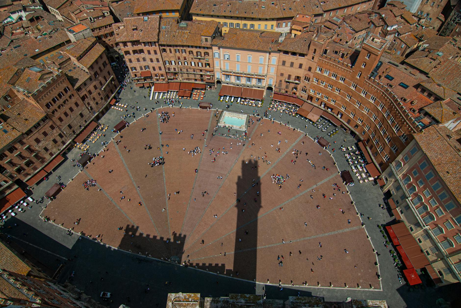 aerial view of people in a courtyard surrounded with buildings