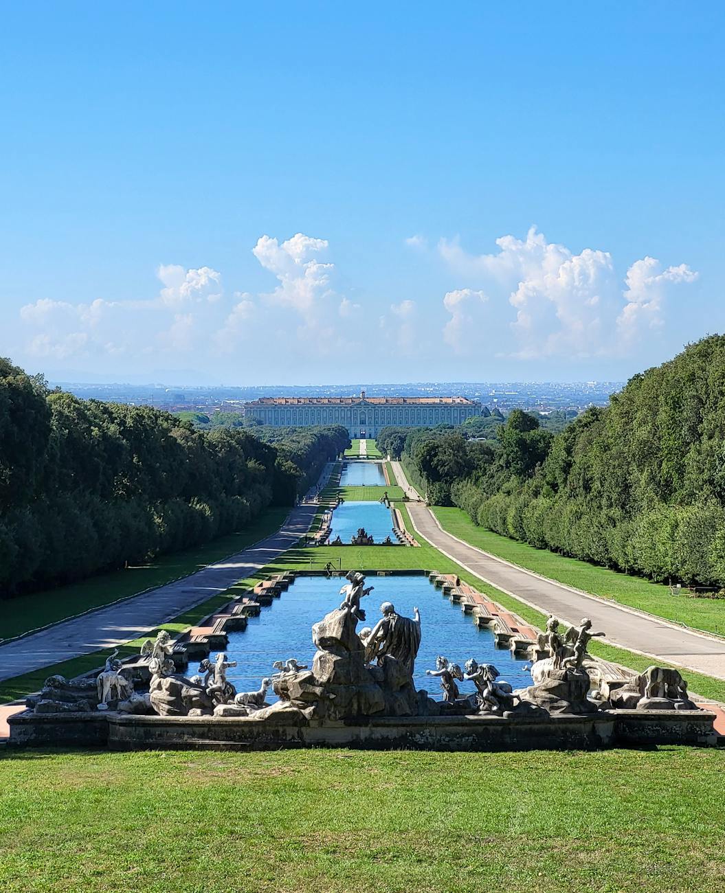 landscape photography of the royal palace of caserta from the fountain of venus and adonis